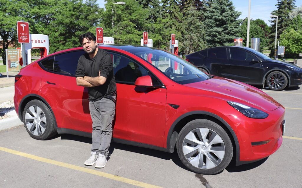 Tesla owner recharging car at Supercharger in Oakville - 345 Speers rd.